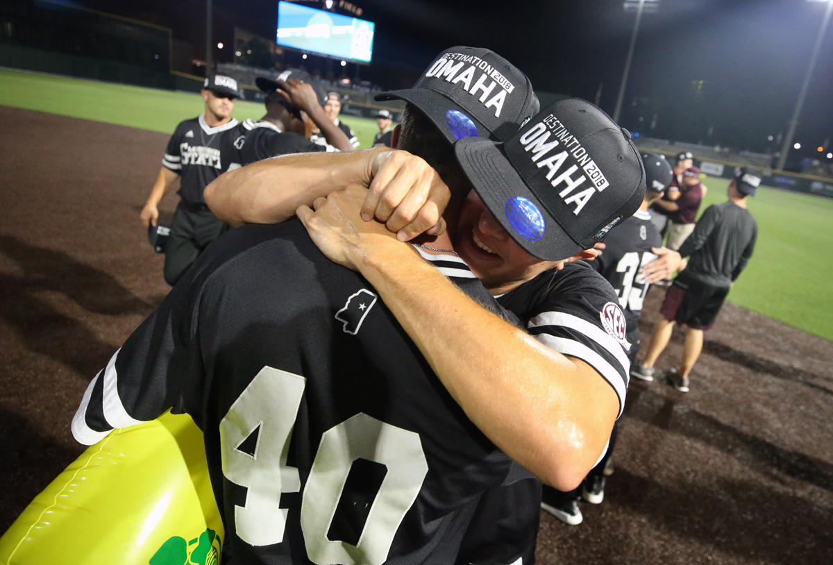 Wearing &amp;quot;Destination 2018 OMAHA&amp;quot; hats, MSU Baseball players hug, celebrating their win against Vanderbilt.