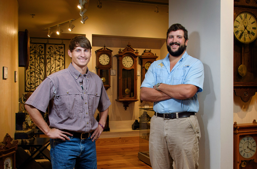 Chase King, left, Shane Carver, right stand in the clock museum.