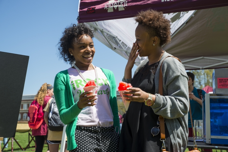 Chelbe Edwards and Erin Youngblood enjoy snowcones being sold on the Drill Field.