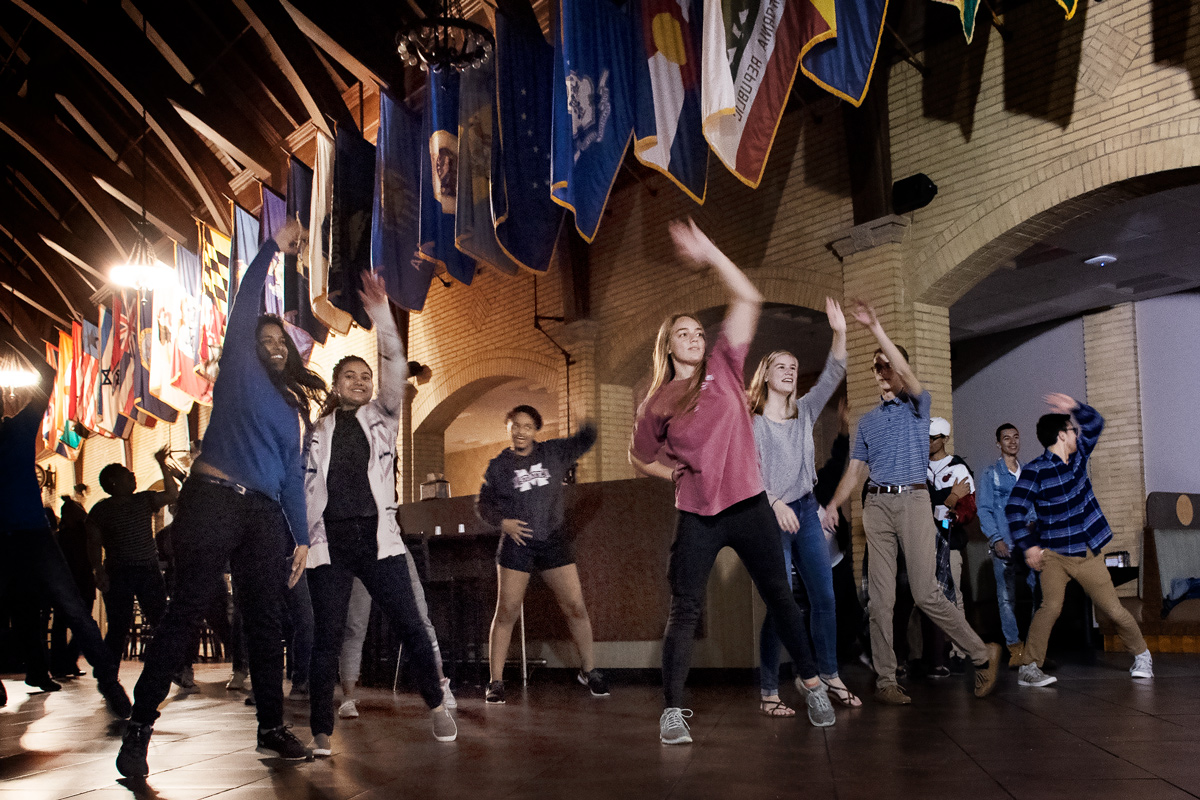 A group of students in the Marketplace at Perry dancing along to Zumba routine