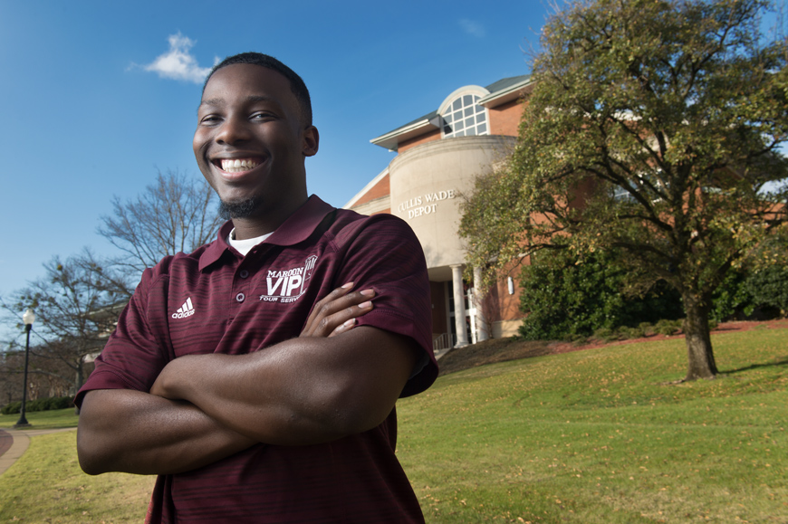 Damian Agee poses in front of the Cuills Wade Depot on the MSU campus.