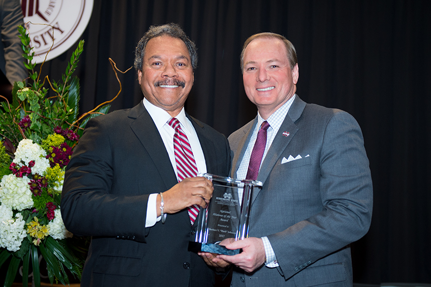 National Alumnus of the Year, Herb Johnson, is congratulated by Dr. Mark Keeun.