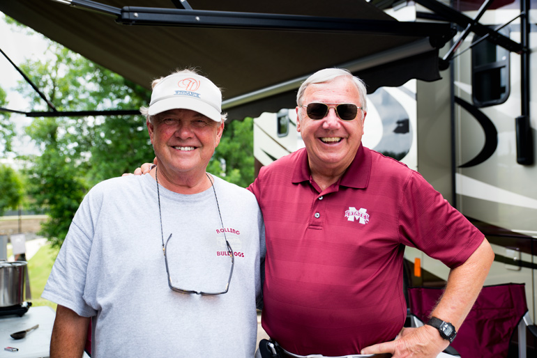MSU alumni Bob Barrett and Wendell Lee relax by their RV as they wait for the Mississippi State baseball game to start.