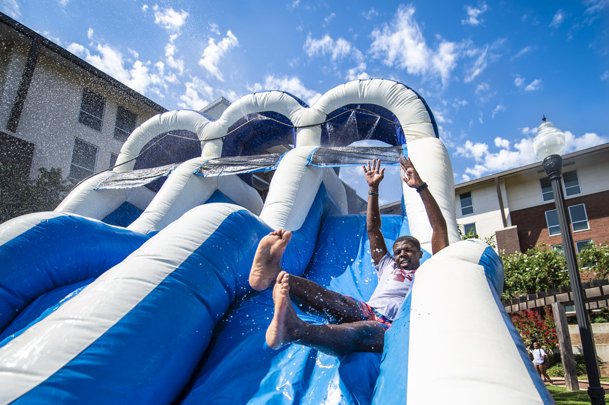 Quantez Perkins gets the College Ready Summer Splash festivities started by going down a water slide.