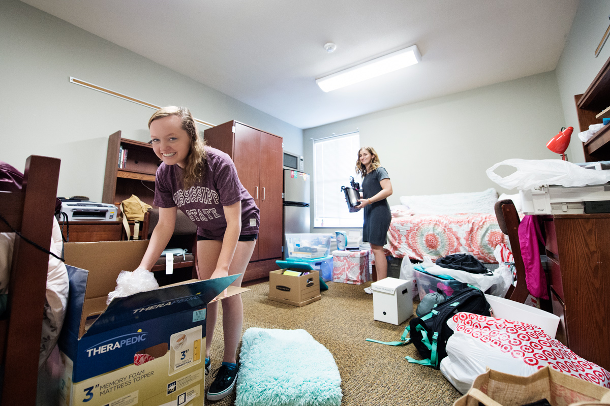 Two roommates unpack boxes in their Hurst Residence Hall room.