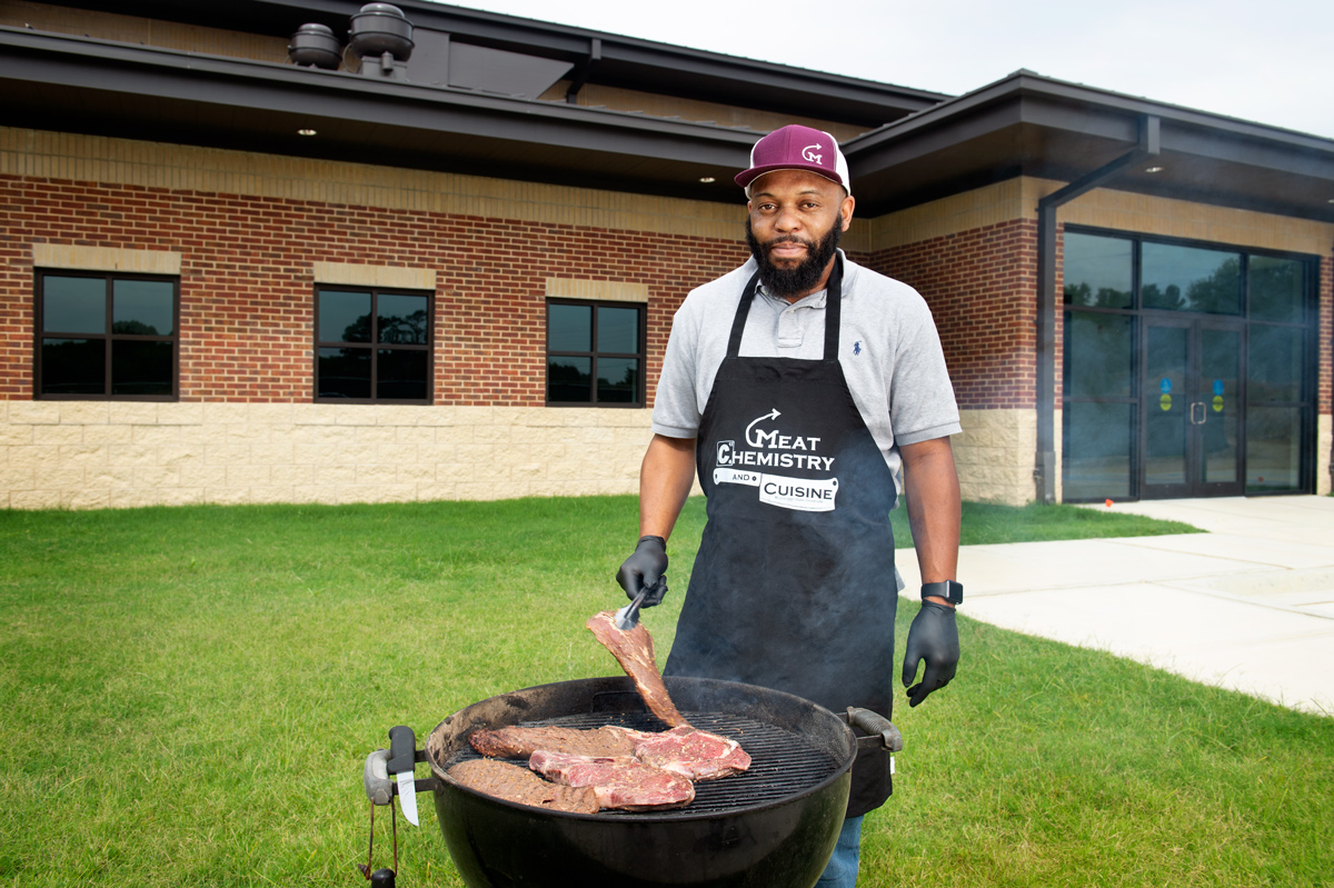 Derris Devost-Burnett, pictured grilling steak on the MSU campus.