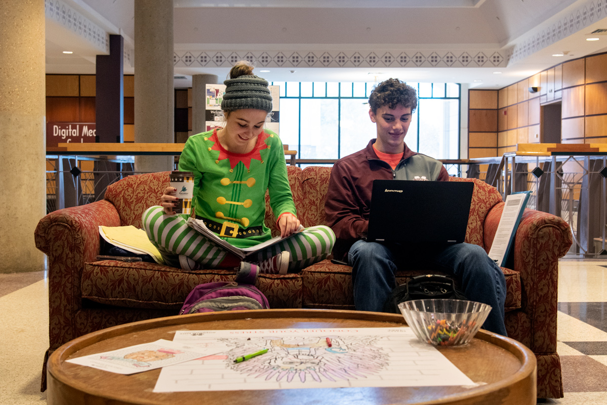 Students Alexis Higgins and Zach Spangler study in festive attire in the Mitchel Memorial Library