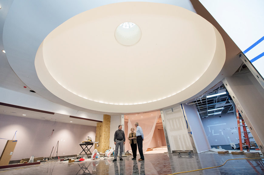 The Grant Presidential Library&amp;#039;s big circular rotunda dwarfs the three figures as they tour the construction site.