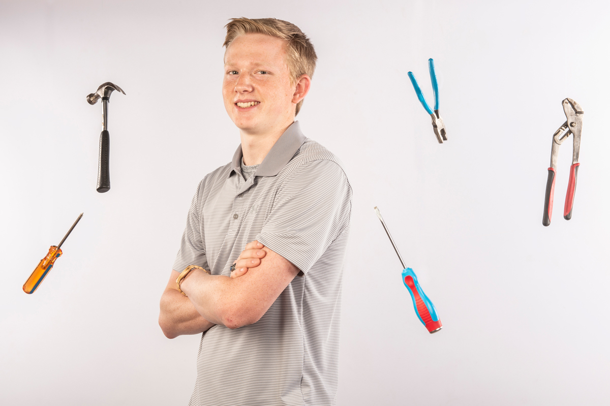 Hunter Barlow, surrounded by work tools.