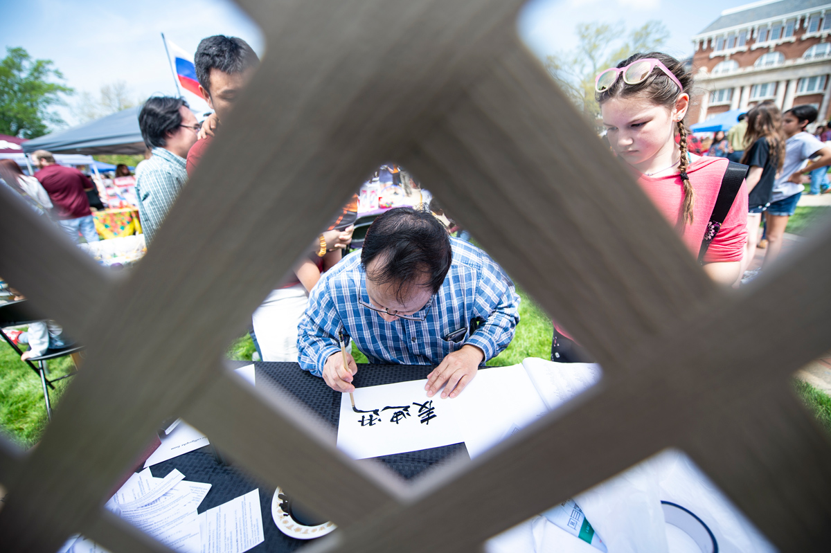 The Starkville MSU Chinese School tent writes the translation of people&amp;#039;s names.  