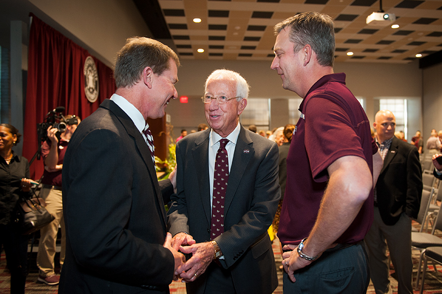 Mississippi State University Bulldog Club Board President Mickey Holliman (center) and Gentry Long (right) greet John Cohen, who was introduced as the university&amp;#039;s 17th director of athletics Friday [Nov. 4] during a press conference at The Mill at MSU.