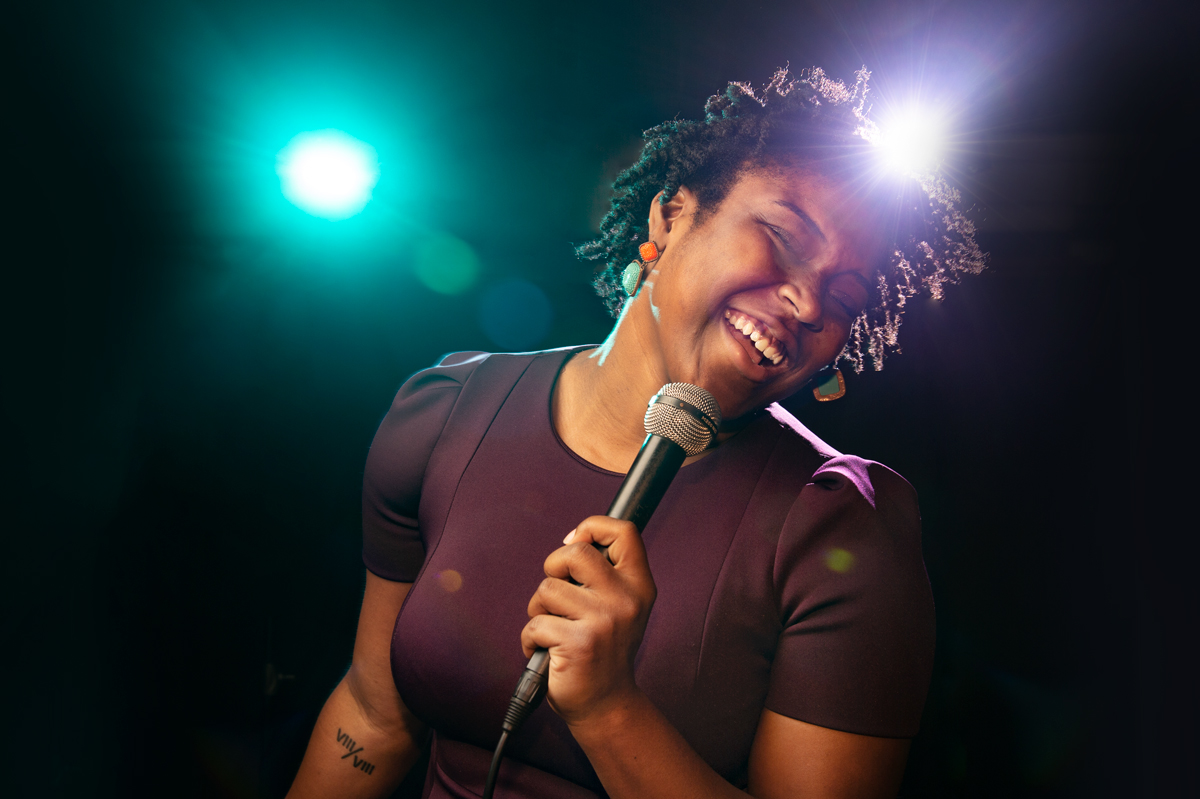 Zierra Long, pictured singing into a microphone.