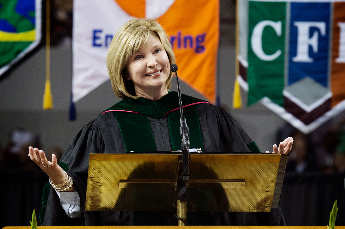 Spring Graduation Commencement Speaker LouAnn Woodward speaking from the podium