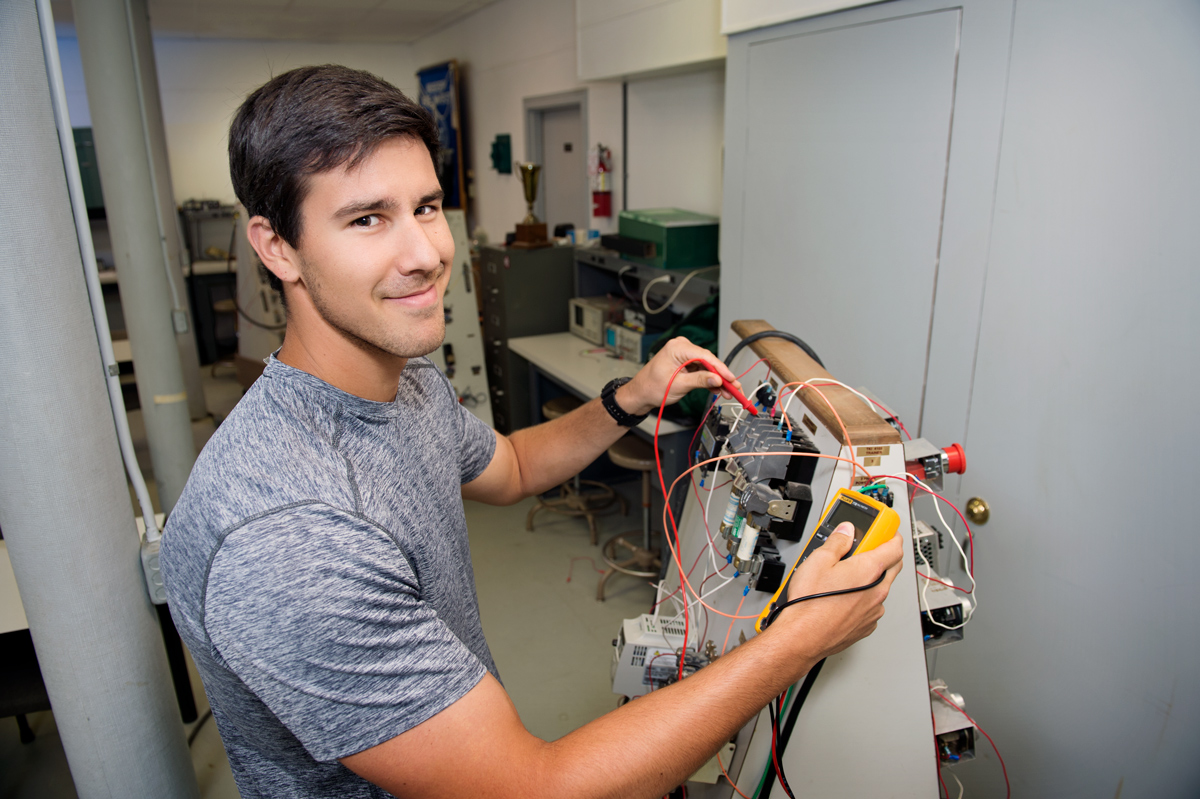 Carson Miller, pictured with industrial technology machines.