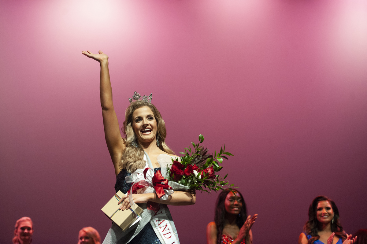 Rachel Shumaker waves to the crowd after being crowned the new Miss Maroon &amp;amp; White.