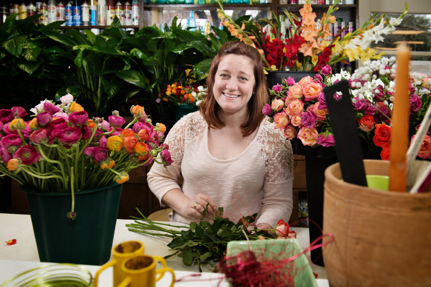 Portrait of Taylor Paine working with flowers at University Florist