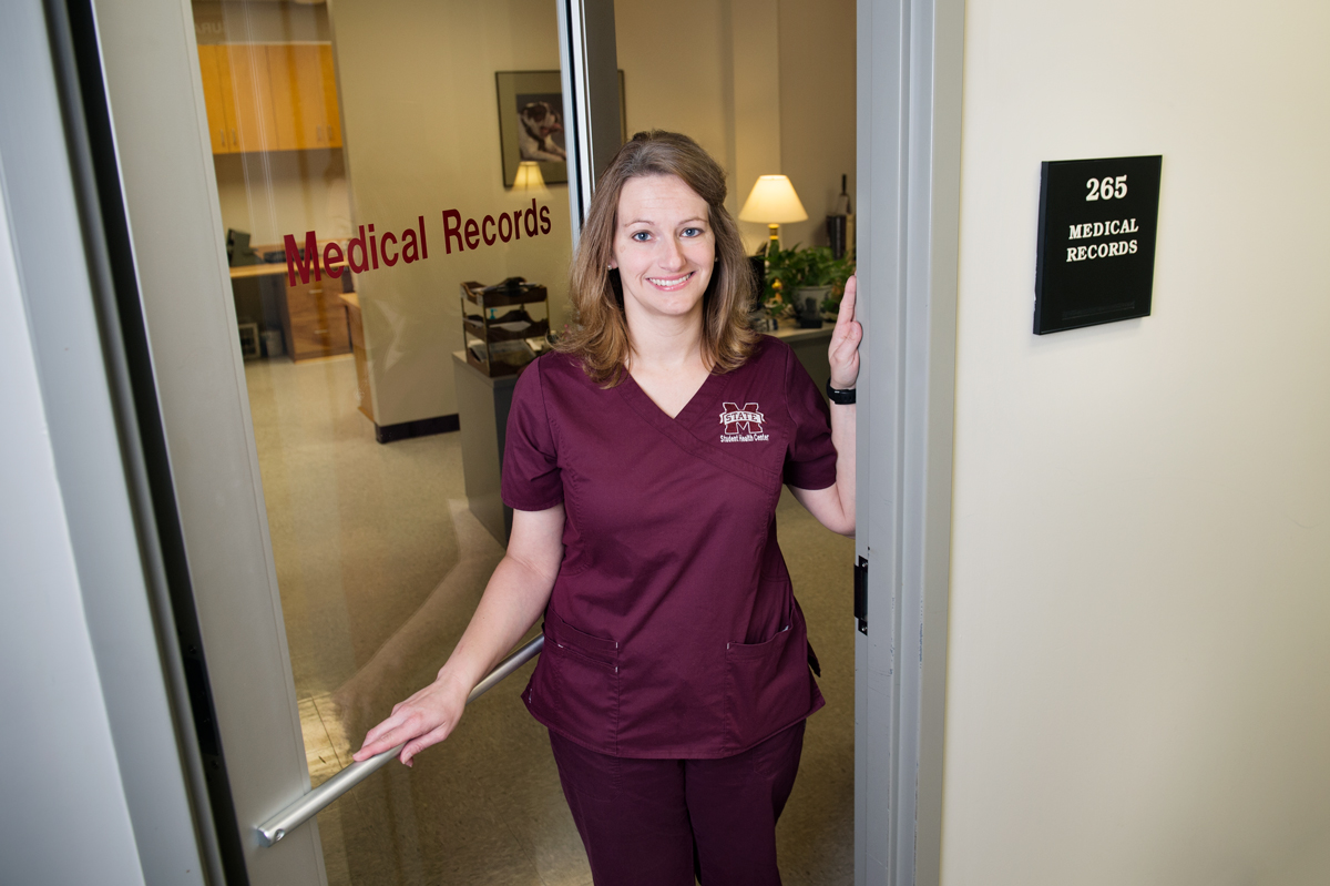 Casey Reed stands in the doorway of the medical records office at the Longest Student Health Center.