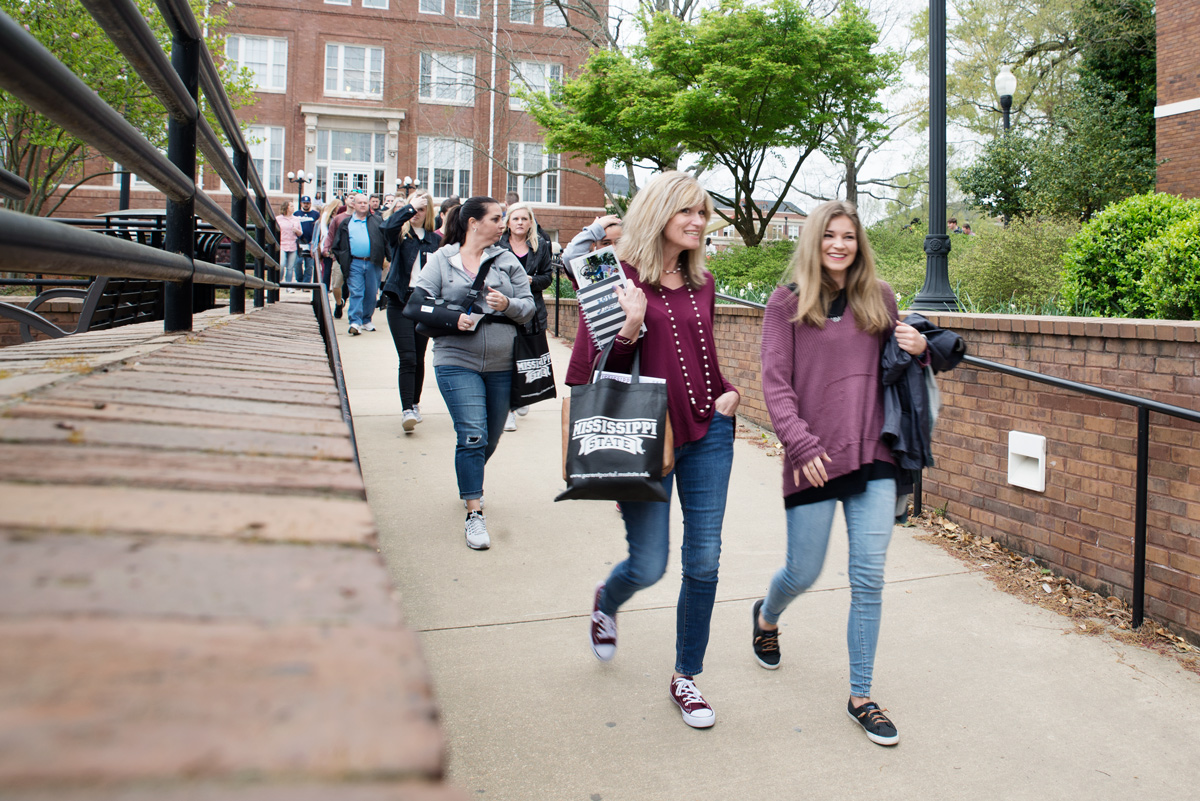 Visiting high school juniors and their parents walk from Lee Hall to Colvard Union during Spring Preview Day.