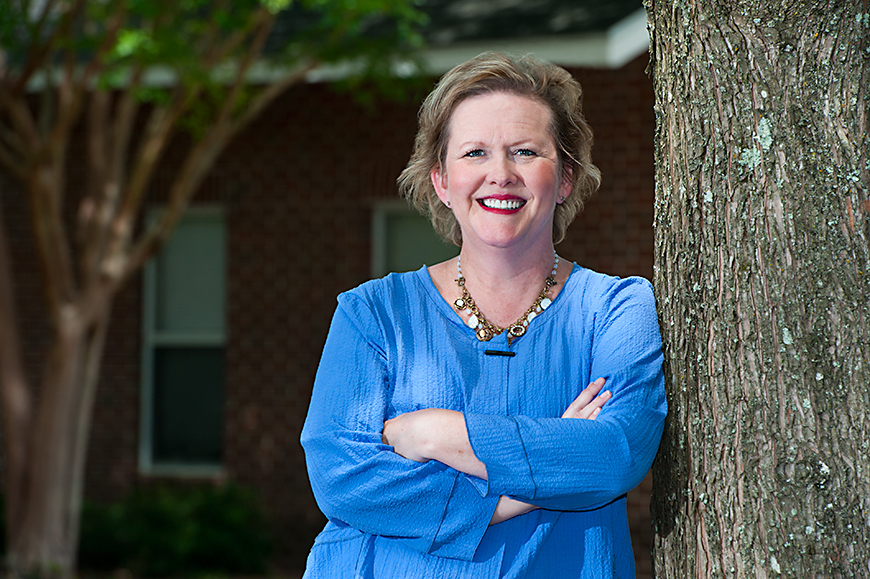 Photo of Melissa Tenhet leaning against a tree.