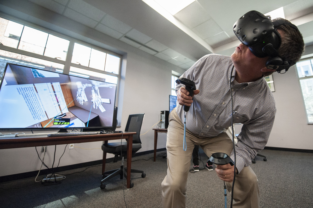 Instructor for Aerospace Engineering Robert Wolz interacts with the 3D Organon VR during a session in the library.