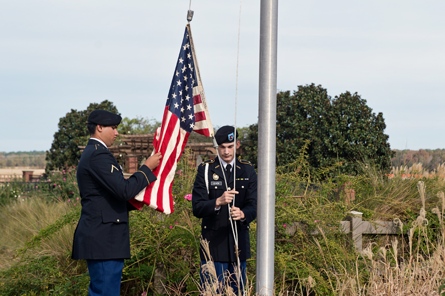 Students Army ROTC cadets raising flag during Veterans Day Ceremony