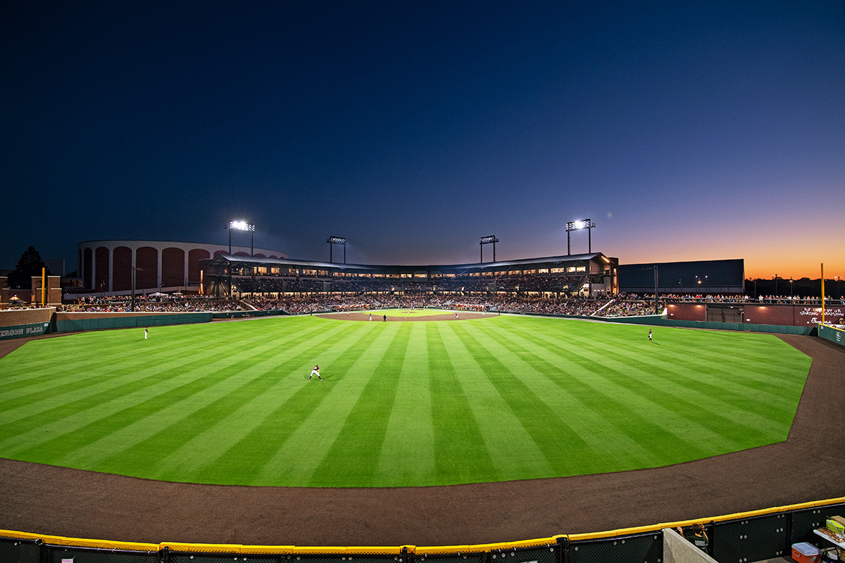Baseball field and grand stand at dusk during game