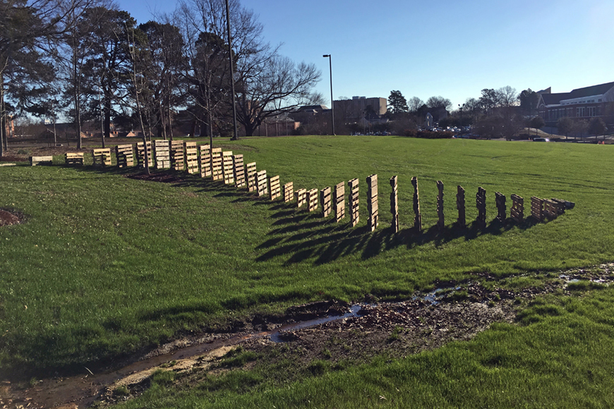 Various sized pallets being used to follow the contours of a hill.