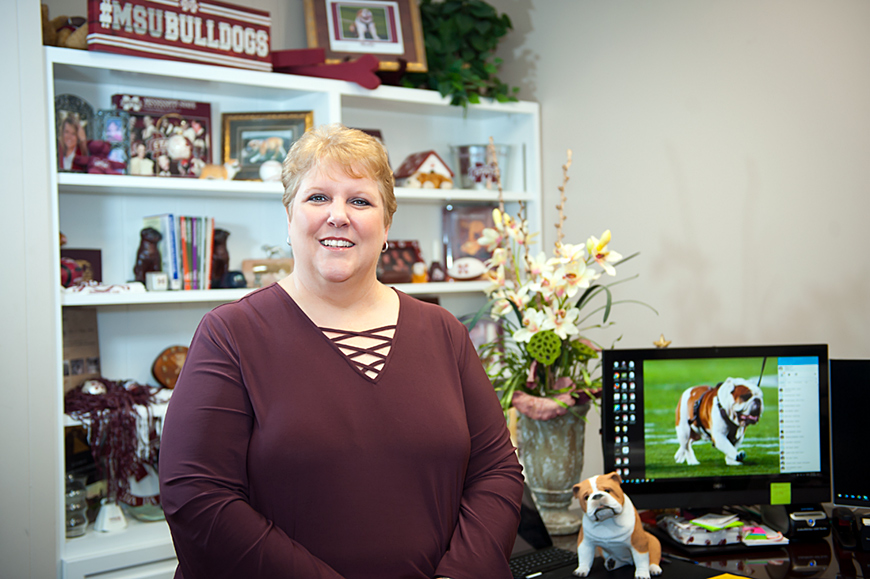 Lorie White stands proudly in her office.