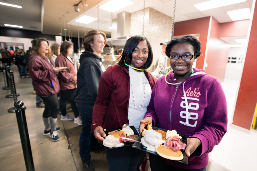 Two female students Khadija Griffin and Jamireya Grant, hold breakfast plates at Fresh Food Company during Finals Break for Breakfast