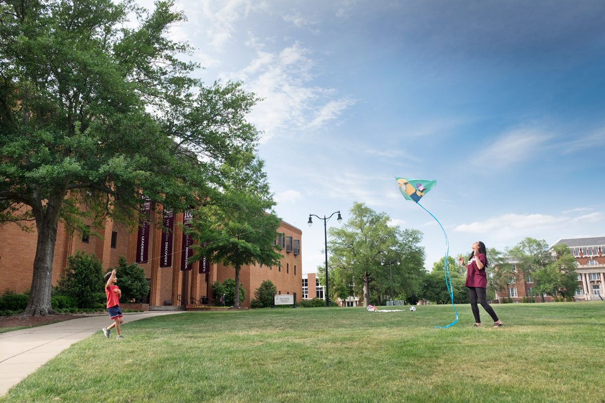 Recent biochemistry graduate Dipa Patel flies a kite on the Drill Field with her six year old brother.