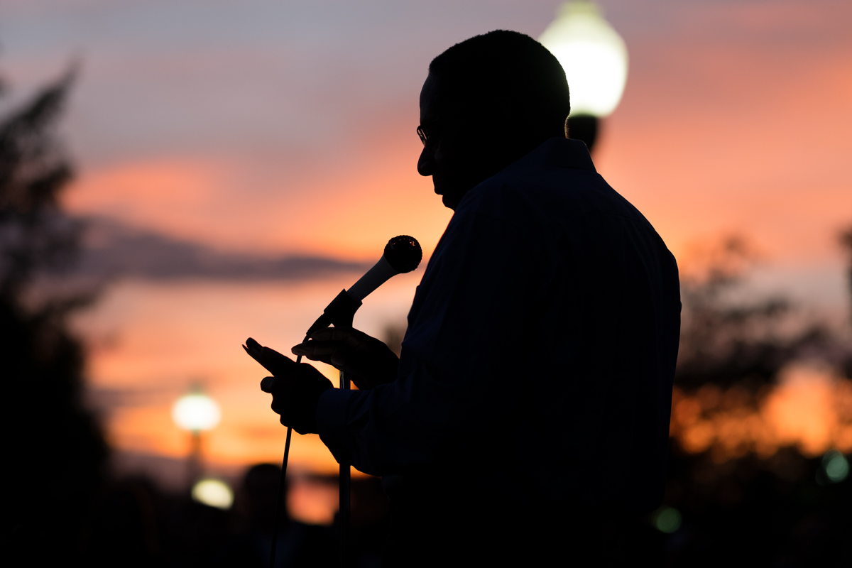 Mississippi Representative Tyrone Ellis is sillhouetted against a sunset during his speech at the Unity Vigil.