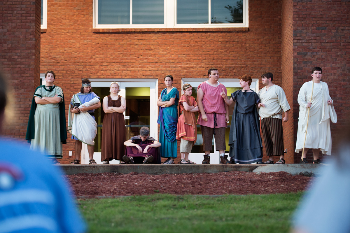 The full cast of 10 toga-clad Honors students joins together on the outdoor stage at the conclusion of their Classical Week play