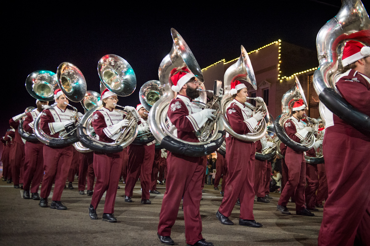 The Sousaphone section of the Famous Maroon Marching Band passes by on Main Street during the Starkville Christmas Parade.