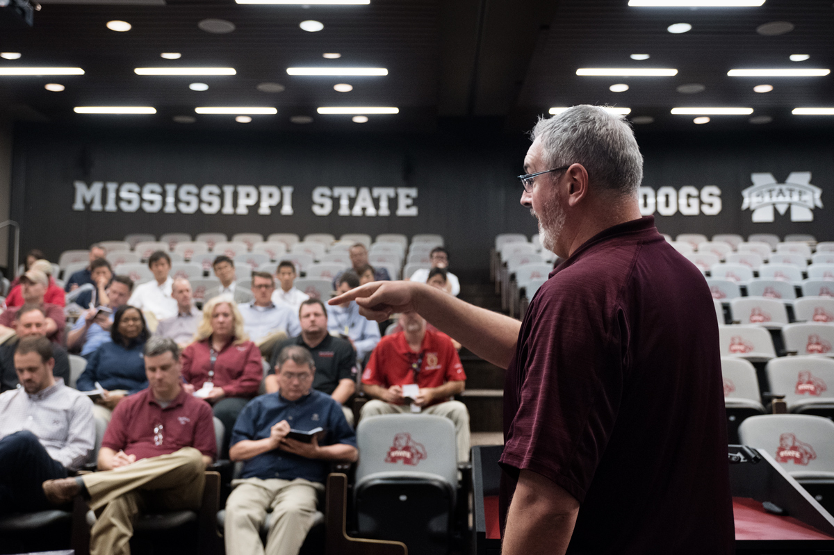 Football Coach Moorhead speaks about leadership to a group of about 40 in the Seal Football Complex.