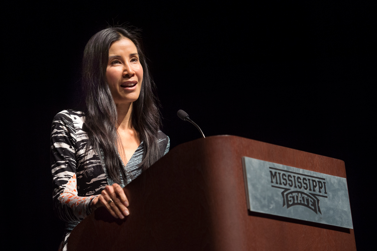 Journalist Lisa Ling speaks from podium with Mississippi State logo.
