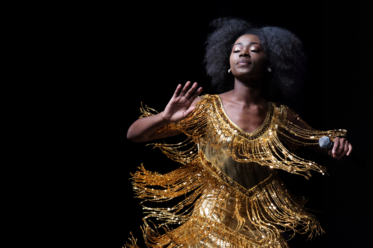 The gold fringe on performer Xeneia Sorrell&amp;#039;s dress flares out as she dances during one of the Back to Black performances. 