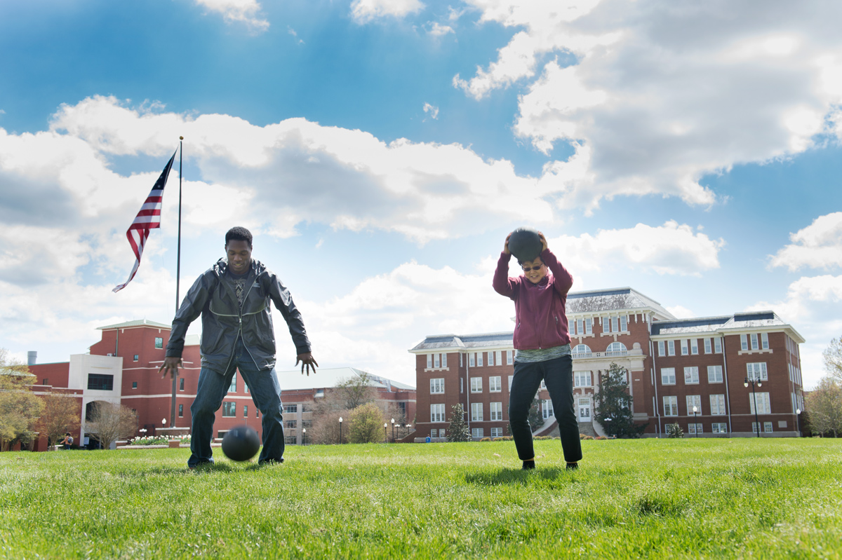As part of an MSU on the Move promotion the sunny Drill Field, a student and a faculty member do &amp;quot;slam ball&amp;quot;.