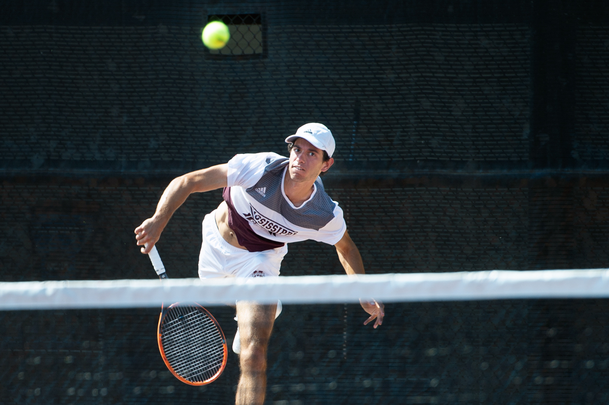 MSU Men&amp;#039;s Tennis player Nuno Borges hits a shot over the net during a singles match.