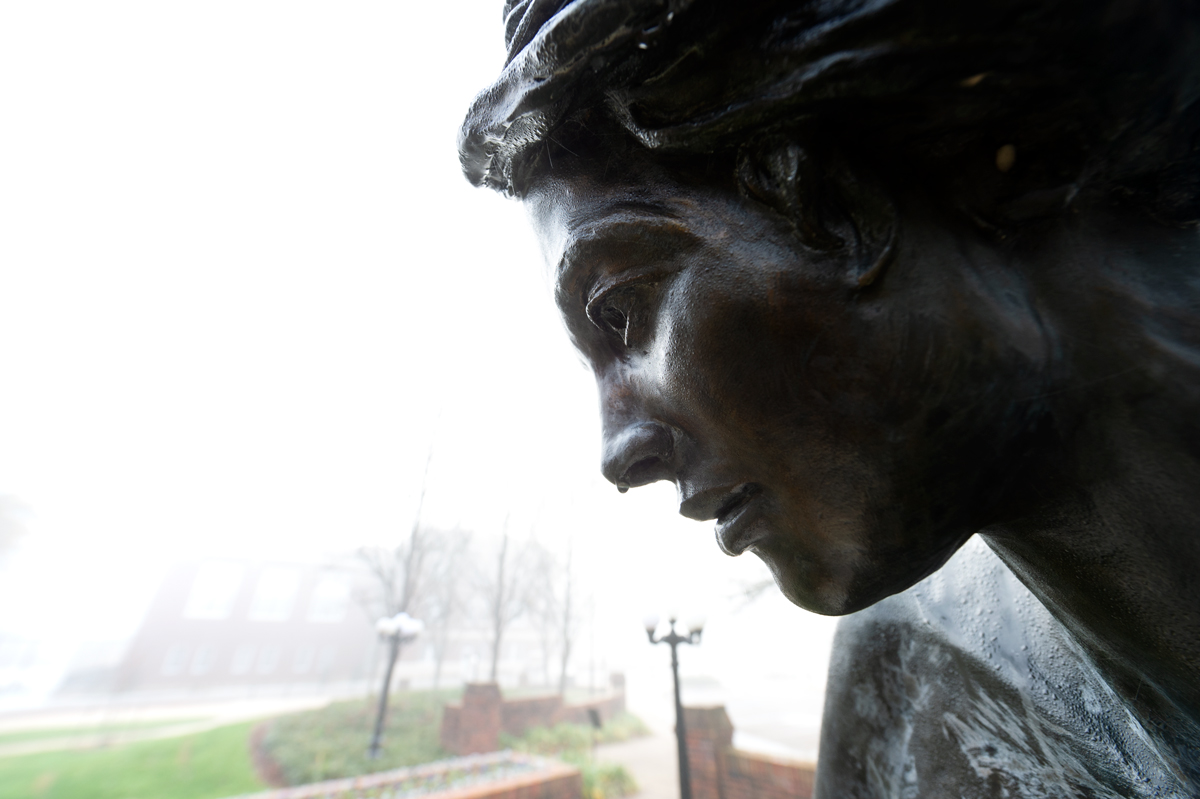 Chapel Angel statue&amp;#039;s face up close on a foggy morning, with a dewy drip on her nose.