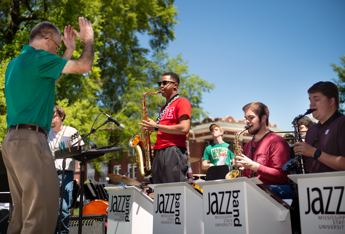 With sunny blue skies as a backdrop, Cliff Taylor directs the Jazz Band, with sax playerTerrell Gilmore standing for a solo.