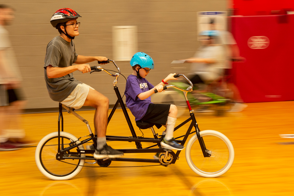 From left: MSU Student Tristan Hendrix rides a Tandem Bicycle with 8-year-old Cameron Knight.