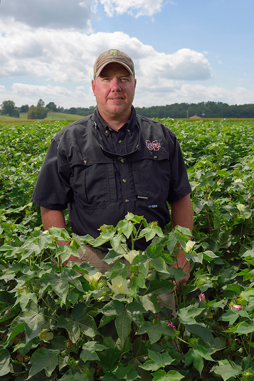 Jeffrey Gore standing in a field.
