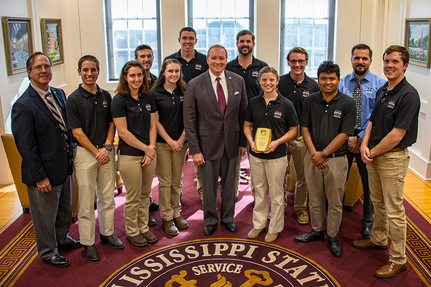MSU President Mark E. Keenum congratulated members of the MSU student chapter of the Society of American Foresters for 20 years of excellence. Pictured are, from left, Associate Dean and Professor Ian Munn; senior forestry/environmental conservation major Marshall A. Callicott of Bryant, Arkansas; senior forestry/forest management major Darcey A. Collins of Bauxite, Arkansas; junior forestry/wildlife management major Rachel E. Nation of Milton, Florida; Keenum; junior forestry/forest management major Samantha “Sam” Seamon of Prattville, Alabama; forestry doctoral student Thu Ya Kyaw of Starkville; and sustainable bioproducts master’s student William Griffin of Philadelphia. Back row, from left, are sophomore forestry/forest management major Adam W. Lindsey of Purvis; senior forestry/forest management major Jordan L. Childs of Grenada; senior forestry/forest management major Matthew S. Harrison of Cherokee, Alabama; junior forestry/urban forestry major Adam C. McKnight of Milton, Florida; and Professor Robert Grala. (Photo by David Ammon)