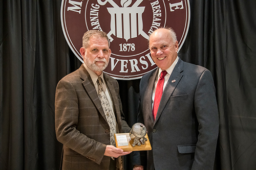 MSU faculty member Kevin Hunt accepts the esteemed Sharp Professorship from MSU College of Forest Resources Dean George Hopper.