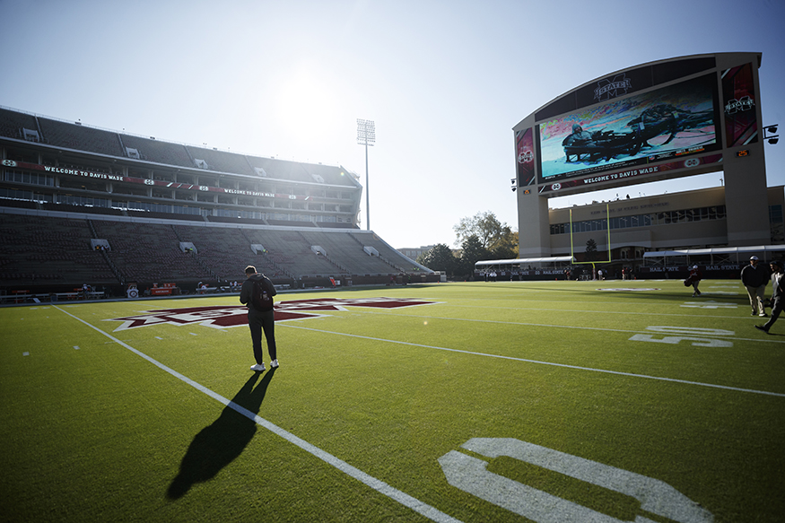 The sun shines down on a Bulldog student-athlete and Mississippi State’s award-winning Scott Field at Davis Wade Stadium.