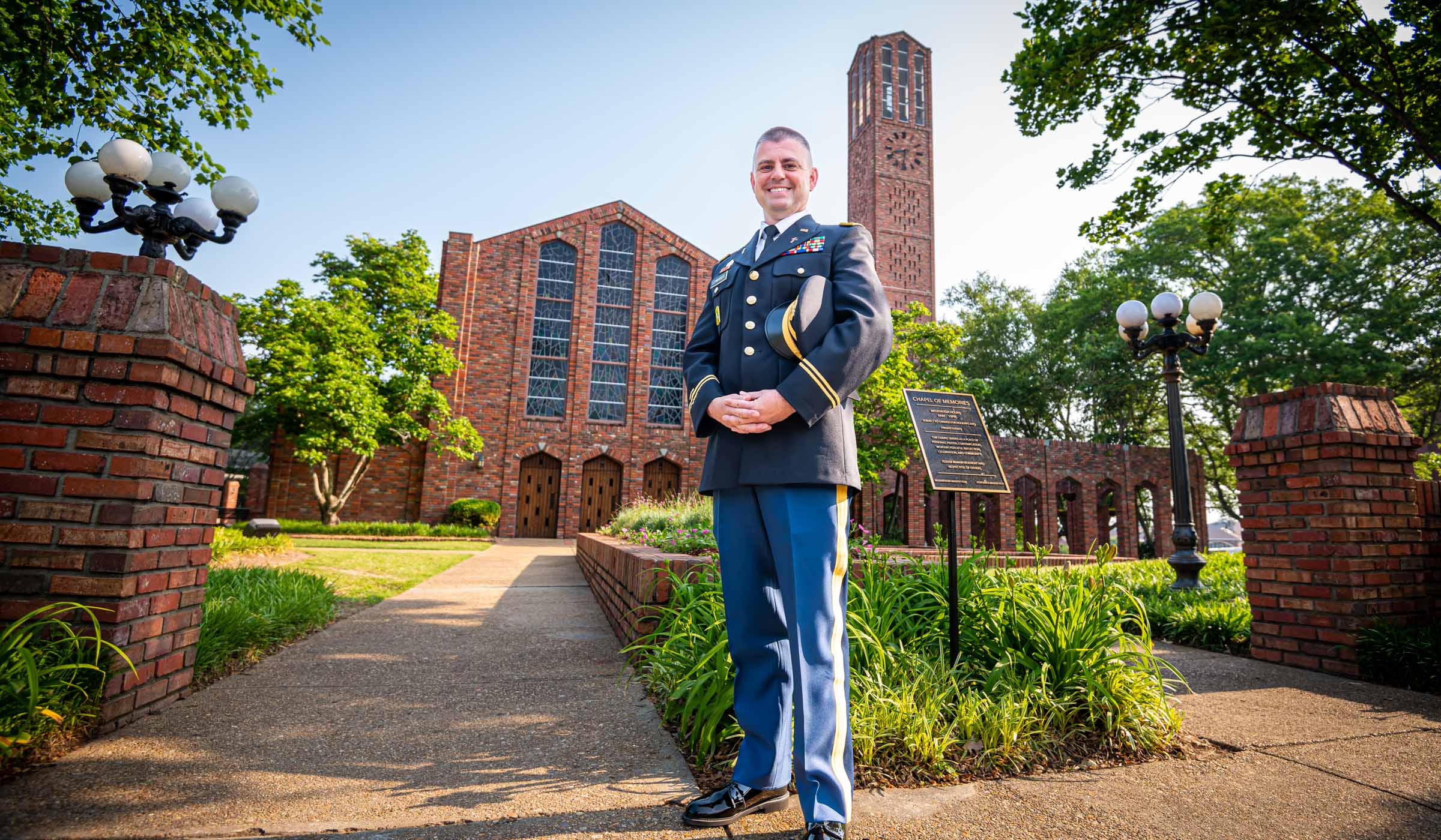 Scott Edwards in uniform standing in front of the Chapel of Memories at MSU