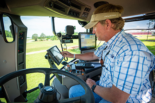 Wes Lowe, assistant agricultural and biological engineering professor, programs the planter. (Photo by David Ammon) 