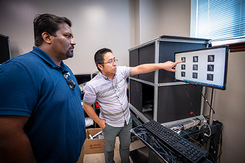 Anuraj Sukumaran (left), assistant professor in the Mississippi State Department of Poultry Science, and Yuzhen Lu, assistant professor in the MSU Department of Agricultural and Biological Engineering, study imaging technology that detects subsurface defects in poultry.