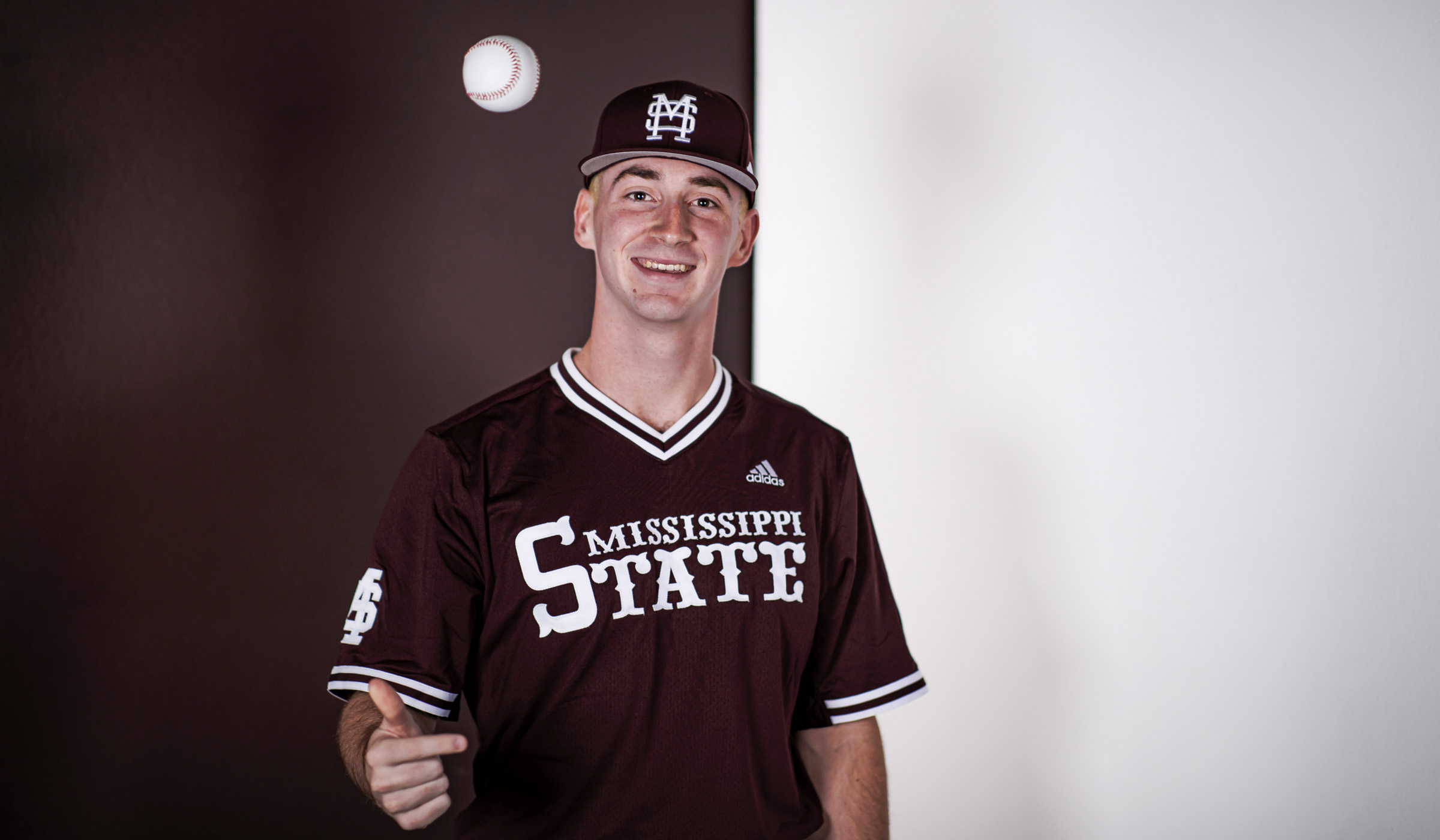 Nate Dohm, pictured wearing a baseball uniform in a photo studio