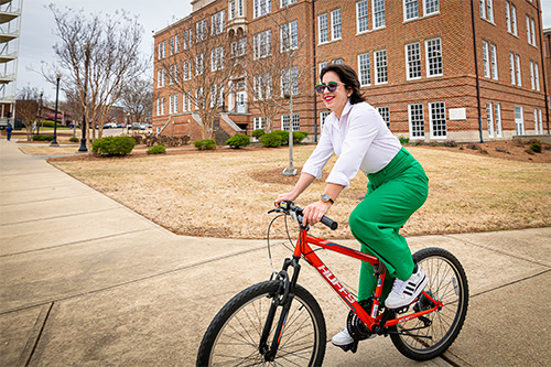 Patricia Marie Cordero-Irizarry rides a bicycle on campus
